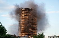 Smoke was still billowing from the 20-story residential building on Monday.