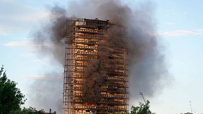 Smoke was still billowing from the 20-story residential building on Monday. Smoke was still billowing from the 20-story residential building on Monday.