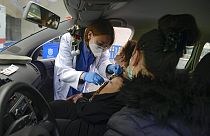 Elena Somalo, 88, receives a Pfizer vaccine in her car during a COVID-19 vaccination campaign in Pamplona, northern Spain, Tuesday, March 16, 2021