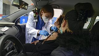 Elena Somalo, 88, receives a Pfizer vaccine in her car during a COVID-19 vaccination campaign in Pamplona, northern Spain, Tuesday, March 16, 2021