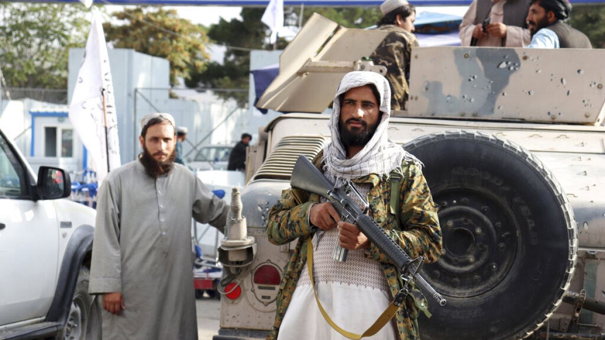 Taliban fighters stand guard in front of the Hamid Karzai International Airport after the U.S. withdrawal in Kabul, Afghanistan, Tuesday, Aug. 31, 2021. 