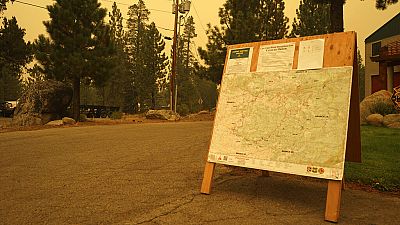 A U.S. Forest Service bulletin board displays information about closures and evacuations at the Lake Valley Fire District Headquarters in Meyers, Calif.
