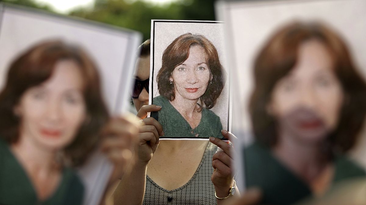 People hold portraits of Natalya Estemirova during a 2009 rally in Moscow.