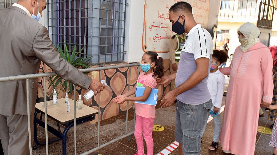 School students and their parents wait to receive their COVID-19 vaccines  as Morocco launches a campaign to vaccinate 12-17 year olds before the  start of the school year, in Rabat, Morocco, Tuesday