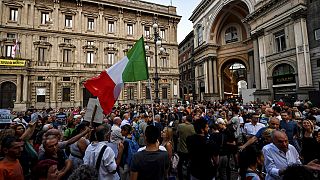 People stage a protest against the COVID-19 vaccination pass in Milan, Italy, Wednesday, July 28, 2021.