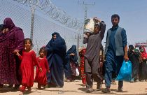 Afghans entering Pakistan through a common border crossing point in Chaman