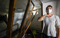 Danny Hong shows where the water reached up to him as he shows the damage in his basement apartment on 153rd St. in the Flushing neighborhood of the Queens borough of New York