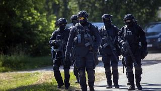 Members of the Lithuanian Police Anti-terrorist Operations Unit ARAS arrive at a refugee camp in the village of Vydeniai.