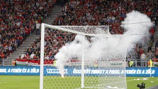 Players wait after a flare was thrown on the field during the World Cup 2022 qualifying match between Hungary and England, in Budapest, Hungary, Sept. 2, 2021.