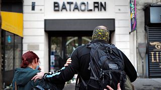 Relatives pay their respects outside the Bataclan concert hall marking the 5th anniversary of the Nov. 13, 2015 attacks, in Paris, Friday, Nov. 13, 2020