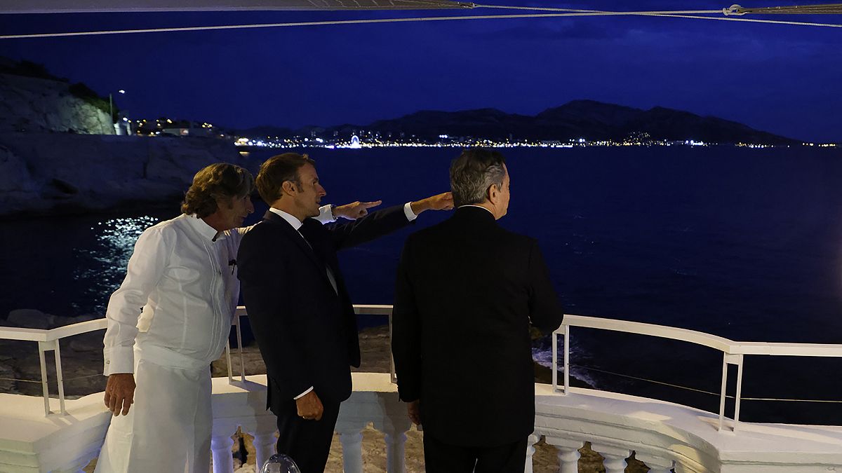 French President Emmanuel Macron, center, French chef Gerald Passedat, left, and Italian Prime Minister Mario Draghi meet before a dinner in Marseille, France.