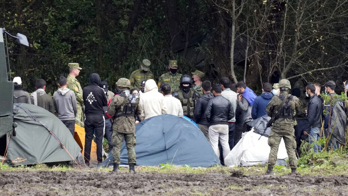 Polish security forces surround migrants stuck along with border with Belarus in Usnarz Gorny, Poland, on Wednesday, Sept. 1, 2021. 