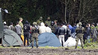 Polish security forces surround migrants stuck along with border with Belarus in Usnarz Gorny, Poland, on Wednesday, Sept. 1, 2021.