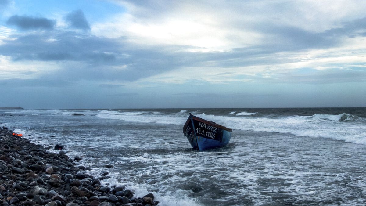 FILE: A wooden boat used by migrants from Morocco is seen grounded on the beach at the southeastern coast of the island of Gran Canaria, Spain, on Thursday, Jan. 7, 2021.