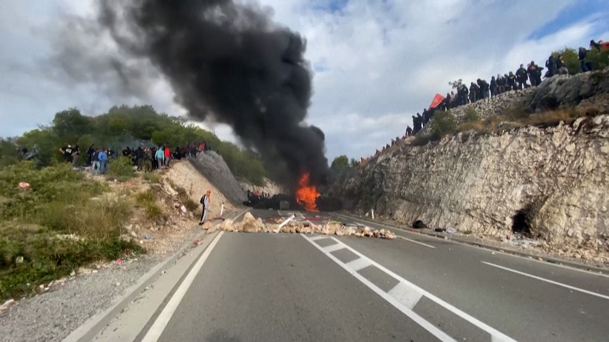 Demonstrators near a road block of burning tyres in Cetinje, Montenegro.