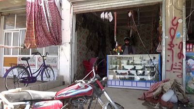 Arms dealer Khan Mohammad manning his store in the Panjwai district of southern Kahdahar.