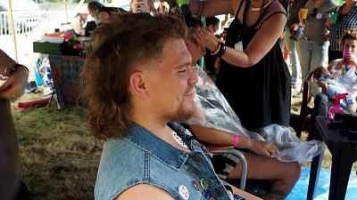A Participant getting a mullet haircut at the European Mullet Cup Championship in the village of "Chéniers", in France's central Creuse region.