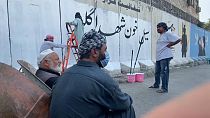 Taliban cover murals on the security wall around Kabul