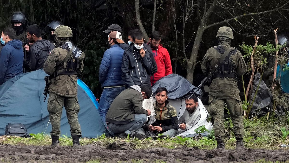 Polish security forces surround migrants stuck along with border with Belarus in Usnarz Gorny, Poland earlier this month