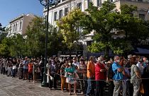 People wait outside the Athens Cathedral to pay respects to the late Greek composer Mikis Theodorakis in Athens on Monday Sept. 6, 2021.