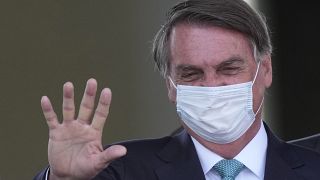 Brazilian President Jair Bolsonaro waves during a ceremony marking Soldier Day at Army headquarters in Brasilia, Brazil, Wednesday, Aug. 25, 2021.