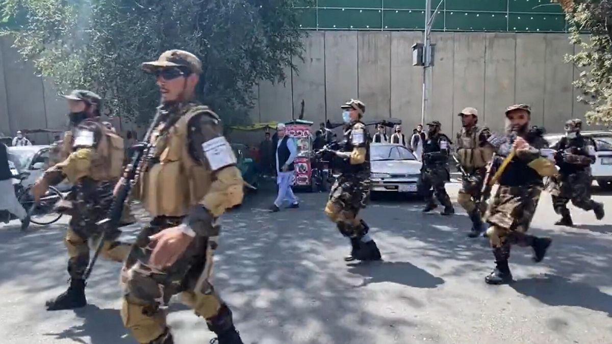 Taliban use gunfire to break Kabul protests.