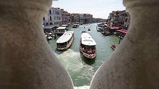 Public transport boats carrying tourists and citizens navigate along the Grand Canal, in Venice, Italy, Thursday, June 17, 2021.