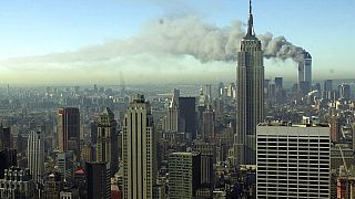 Smoke billows across the New York City skyline after two hijacked planes crashed into the twin towers on Sept. 11, 2001.