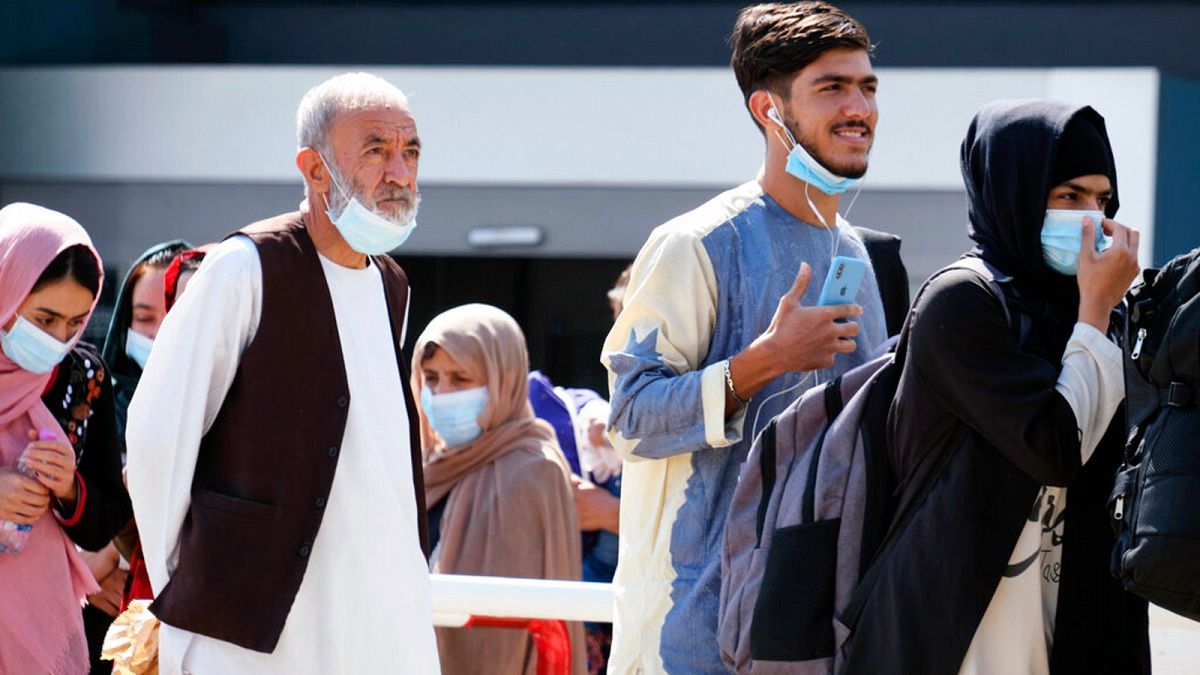 People evacuated from Afghanistan arrive at the Rome Leonardo da Vinci airport, Saturday, Aug. 28, 2021. 