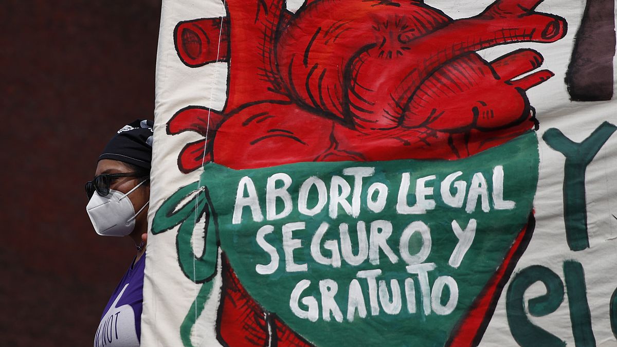  In this Sept. 28, 2020 file photo, a woman holds a banner reading: "legal, safe, and free abortion" in Mexico City.