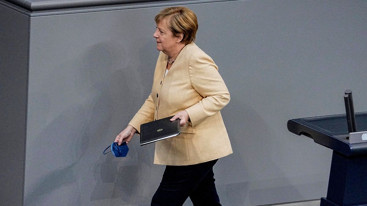 German Chancellor Angela Merkel leaves the lectern after her speech in the plenary session in the German Bundestag in Berlin, Germany, Tuesday, Sept.7, 2021.