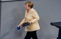 German Chancellor Angela Merkel leaves the lectern after her speech in the plenary session in the German Bundestag in Berlin, Germany, Tuesday, Sept.7, 2021.