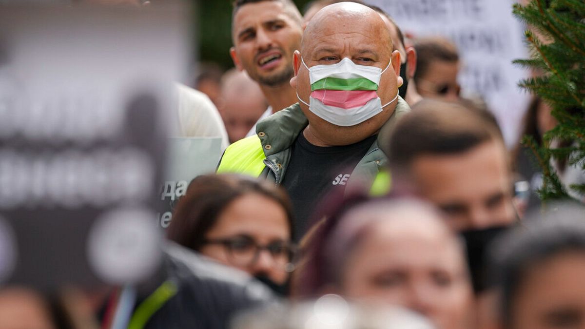 A man wears a mask in the colors of the Bulgarian flag while attending a protest by restaurant workers in Veliko Tarnovo, Bulgaria, Thursday, Sept. 2