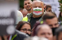 A man wears a mask in the colors of the Bulgarian flag while attending a protest by restaurant workers in Veliko Tarnovo, Bulgaria, Thursday, Sept. 2