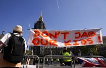 A banner against giving children coronavirus vaccines is displayed during a protest on Parliament Square opposite the Houses of Parliament, in London, Wednesday, Sept. 8, 2021
