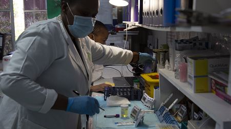 Laboratory technicians test a blood sample for HIV infection at the Reproductive Health and HIV Institute (RHI) in Johannesburg