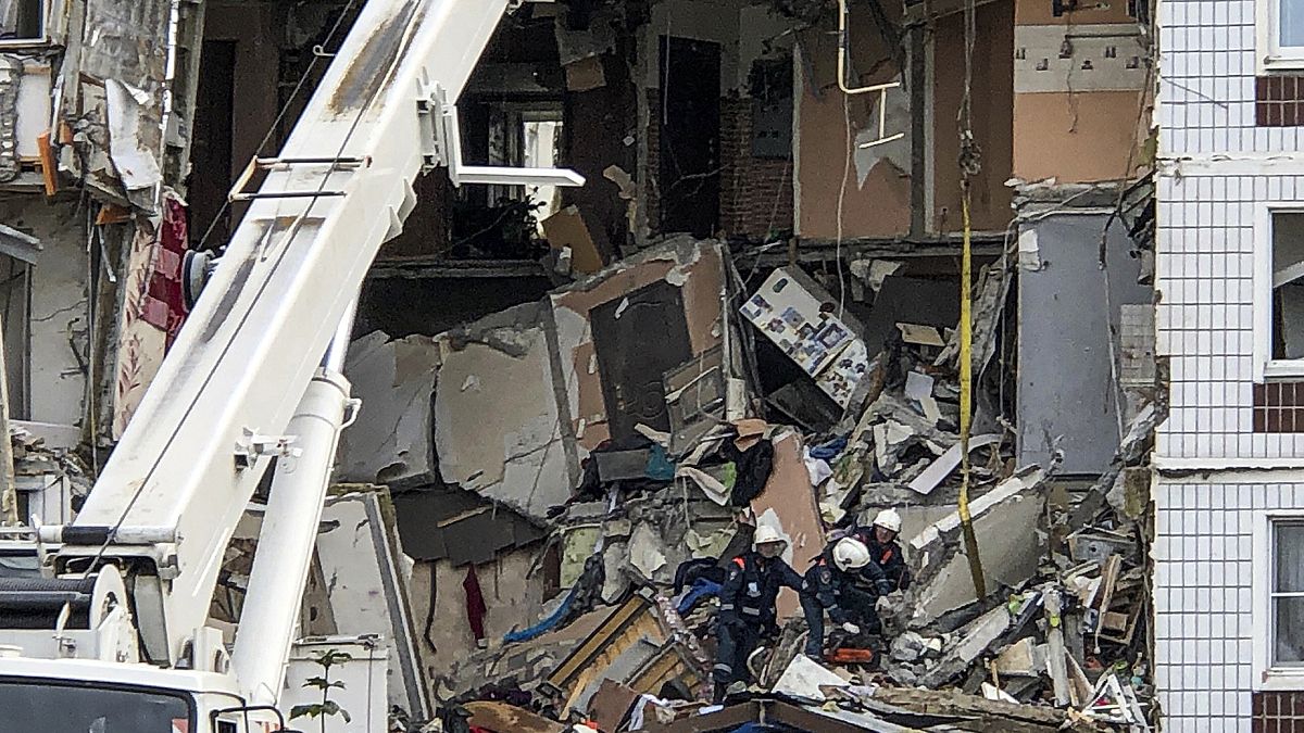 Members of the Emergency services work at the site of a gas explosion.
