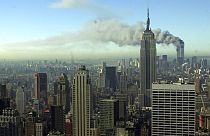 Smoke billows across the New York City skyline after two hijacked planes crashed into the twin towers on Sept. 11, 2001.