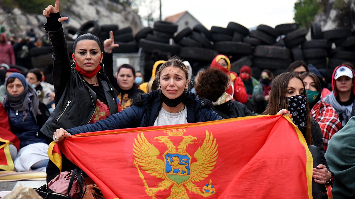 Demonstrators gather at a barricade set up to block access roads to Cetinje during a protest against the inauguration of the new head of the Serbian Orthodox Church