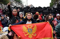 Demonstrators gather at a barricade set up to block access roads to Cetinje during a protest against the inauguration of the new head of the Serbian Orthodox Church Demonstrators gather at a barricade set up to block access roads to Cetinje during a protest against the inauguration of the new head of the Serbian Orthodox Church