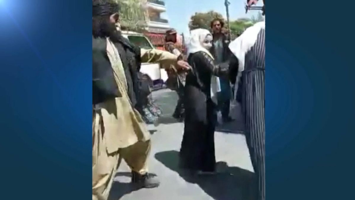Taliban forces use whips to hit women at a protest in Kabul on September 8, 2021. 