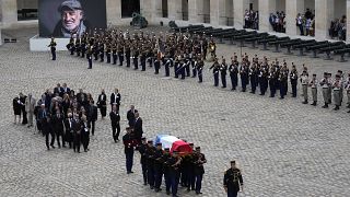 Republican Guards carry the coffin of Jean-Paul Belmondo after a tribute ceremony for the late French actor at the Hotel des Invalides.