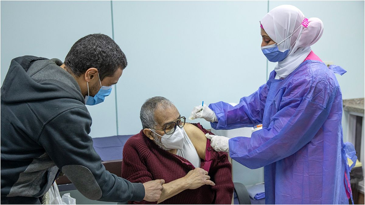 رجلٌ يتلقّى لقاحاً مضاد لفيروس كورونا في مستشفى النزهة بالعاصمة المصرية القاهرة