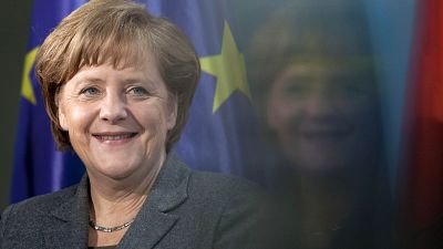 Chancellor Angela Merkel smiles during the presentation of a special edition of a two Euro coin at the chancellery in Berlin, Germany, on 9 February 2012.