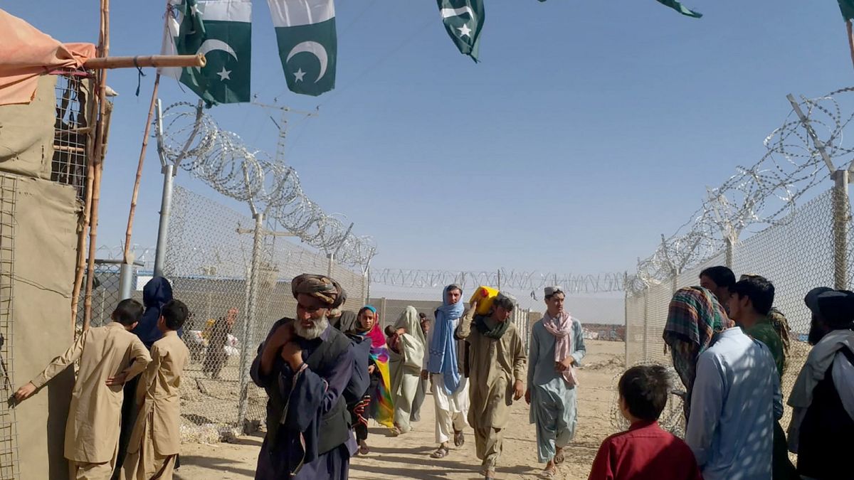 Afgán emberek érkeznek Pakisztánba a csamani határátkelőnél, a tálib hatalomátvétel után