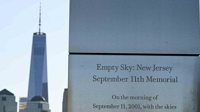 The One World Trade Center is seen behind a memorial plaque at the Empty Sky 9/11 Memorial in Liberty State Park in Jersey City.