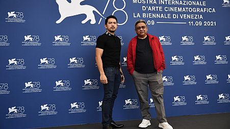 Filipino actor Dennis Trillo (L) and Filipino director Erik Matti attend a photocall for the film "On the Job: The Missing 8" at the Venice Film Festival on September 10, 2021