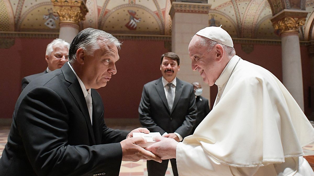 Pope Francis (R), Hungarian Prime Minister Viktor Orban (L) and Hungarian President Janos Ader (back C) exchanging gifts.