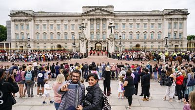Members of the public watch the Changing of the Guard ceremony at Buckingham Palace, London, Monday August 23, 2021 Members of the public watch the Changing of the Guard ceremony at Buckingham Palace, London, Monday August 23, 2021
