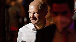In this Sept. 7, 2021 file photo, Olaf Scholz (SPD), his party's top candidate in the upcoming federal election, visits a public viewing of the SPD in the bar "Strandsalon".